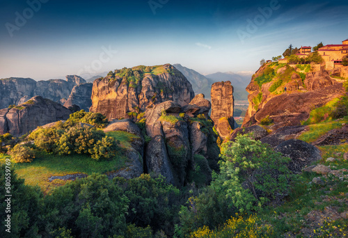 Majestic summer view of famous Eastern Orthodox monasteries listed as a World Heritage site, built on top of rock pillars. Superb morning scene of Kalabaka, Greece. Traveling concept background.