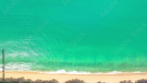 .aerial top view above white sand beach..turquoise sea at Thy Maung beach Phang Nga. 4k colorful blue sea background..beautiful nature in the long beach with pine trees. fishing boat background... photo