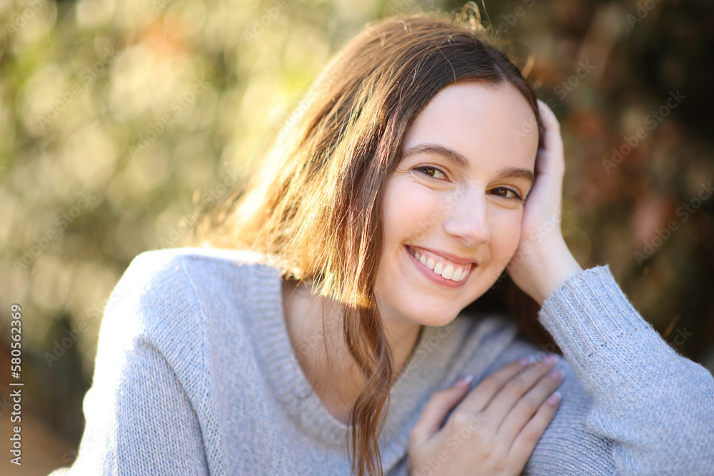 Portrait of a happy woman looking at camera in a park Portrait of a happy woman looking at camera in a park