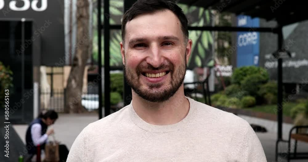 Portrait of attractive stylish young bearded man looking into the camera and smiling. Portrait of attractive stylish young bearded man looking into the camera and smiling.