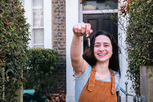 Happy woman showing new home keys photo