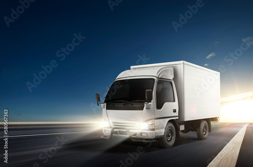 White truck driving on the speedway during sunset. Cargo logistic and freight shipping concept. 3D rendering.