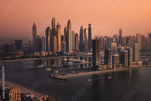 Dubai skyline on sunset, modern city with skyscrapers