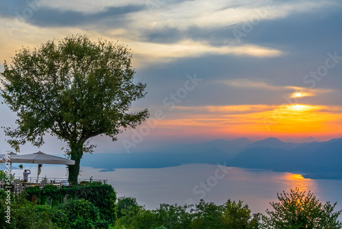 Italy, Veneto, San Zeno di Montagna, Lake Garda at cloudy sunset photo