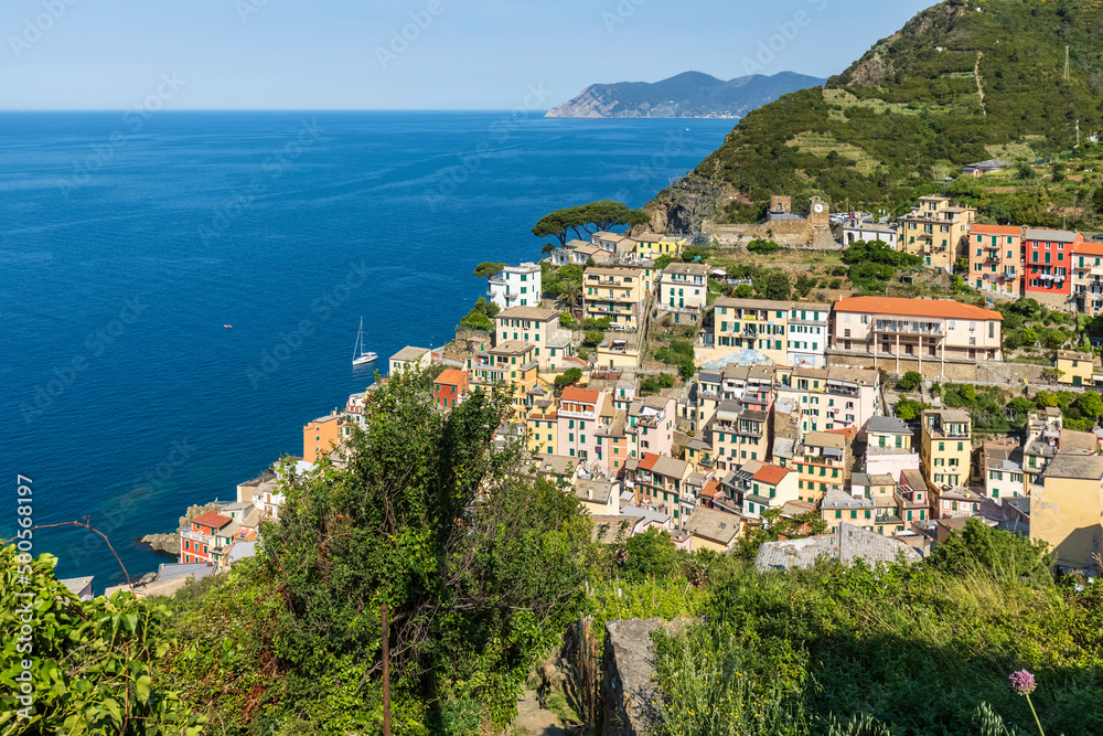 Italy, Liguria, Riomaggiore, View of coastal town along Cinque Terre in summer Italy, Liguria, Riomaggiore, View of coastal town along Cinque Terre in summer