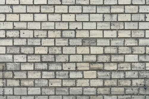 Gray brick wall. Abstract pattern texture. Details of building facade