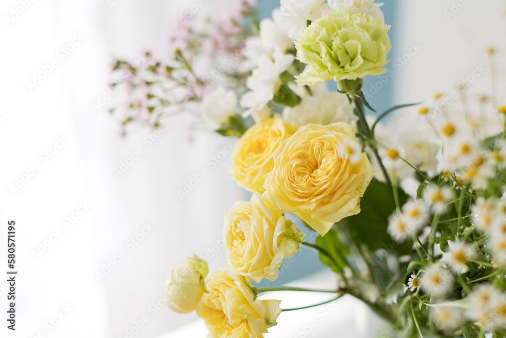 Yellow and white flowers on table