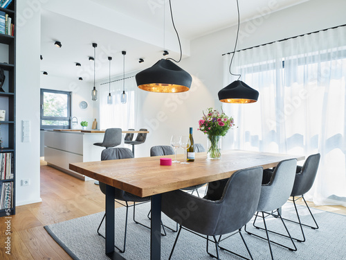 Dining table with chairs arranged in living room