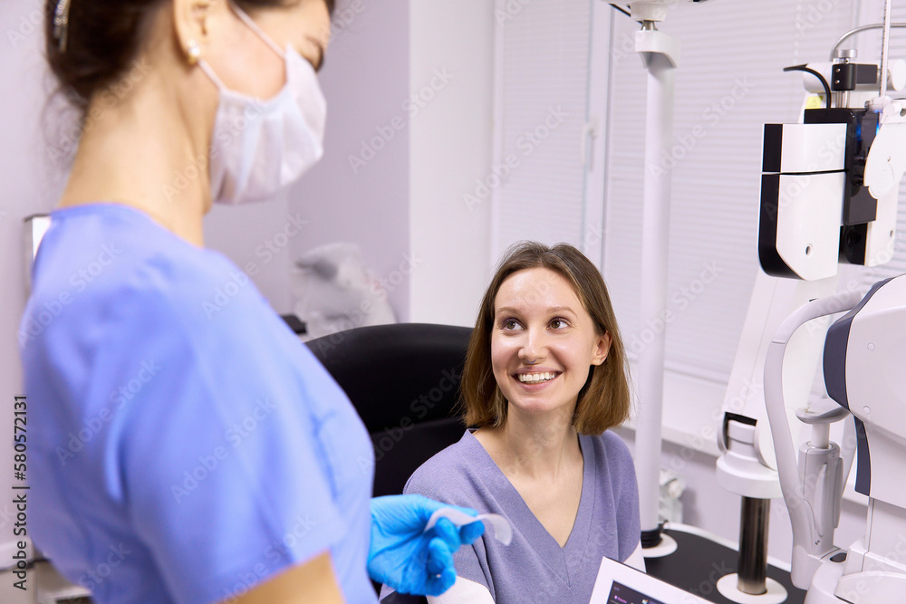 Happy patient looking at doctor in clinic Happy patient looking at doctor in clinic