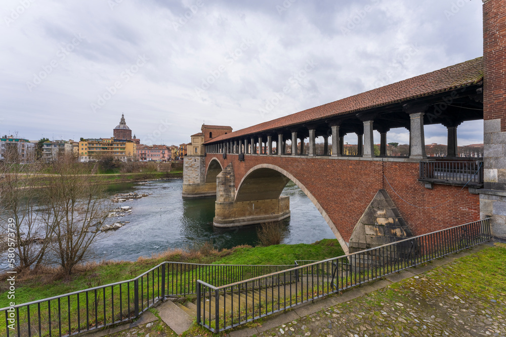 Skyline of Pavia , Ponte Coperto(covered bridge) is a bridge over the Ticino river in Pavia at cloudy day, Pavia Cathedral background, Italy