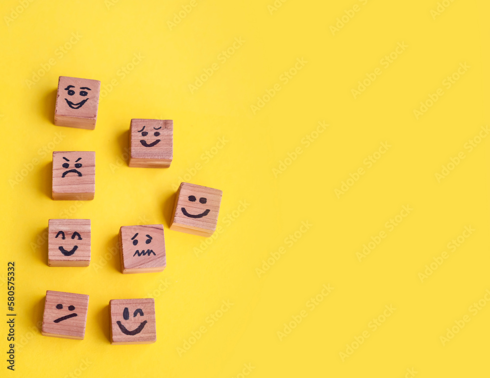 Many cubes with different emotions on yellow background . Empathy and Emotional Intelligence Concept Many cubes with different emotions on yellow background . Empathy and Emotional Intelligence Concept