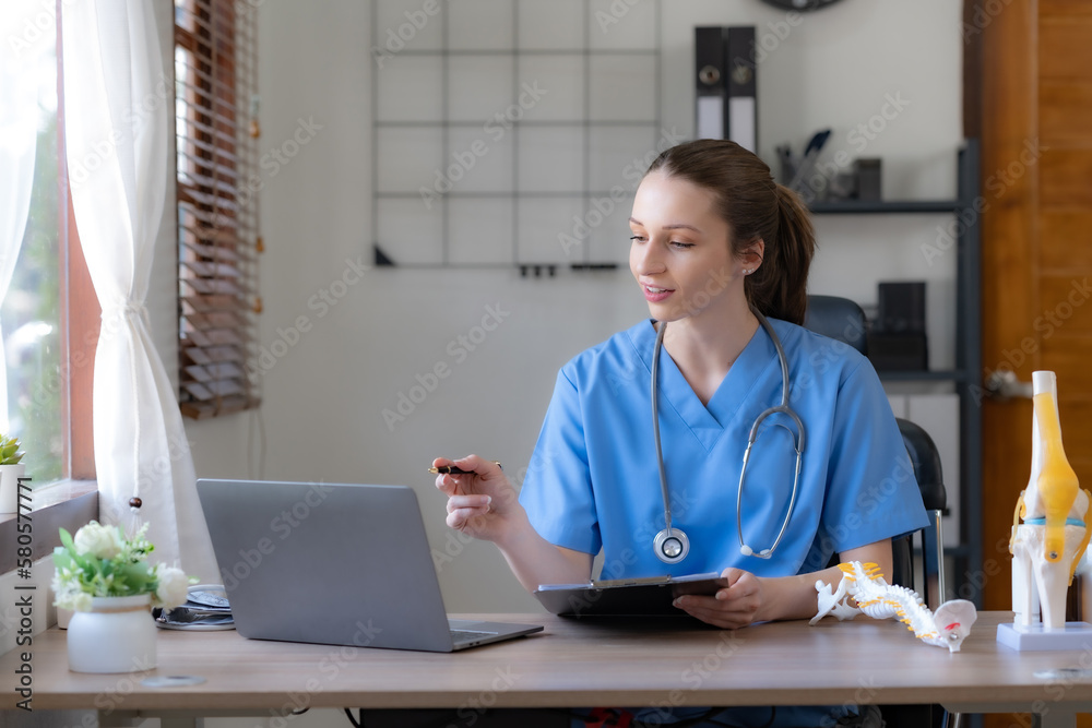 Female doctor or young nurse sitting and working with laptop in clinic or hospital. Female doctor or young nurse sitting and working with laptop in clinic or hospital.