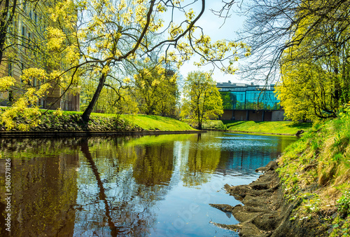 spring view on a river chanel in a green city park