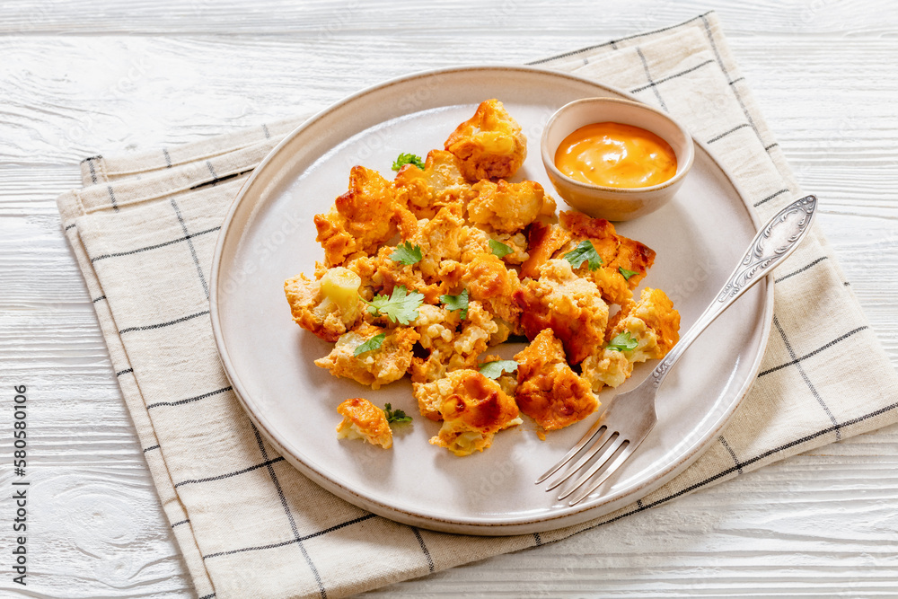 baked Cauliflower florets with sauce on plate baked Cauliflower florets with sauce on plate