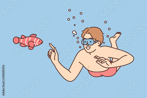 Smiling man in goggles swim underwater 