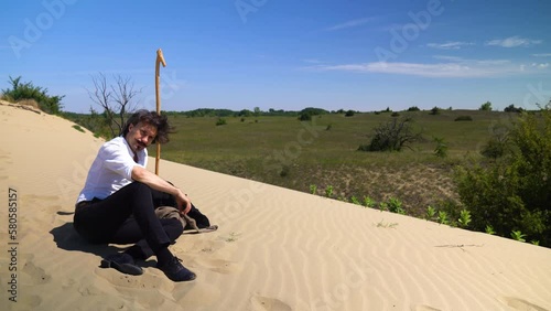 Famous poet Sandor Petofi resting on sand dune, thinking. Actor portrayal. photo