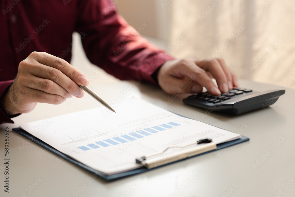 A financier is reviewing company financial documents, monthly financial statement summary from the finance department. The concept of managing the company's finances for accuracy and growth. A financier is reviewing company financial documents, monthly financial statement summary from the finance department. The concept of managing the company's finances for accuracy and growth.