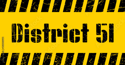 District 51 sign on a yellow background with stencil font.