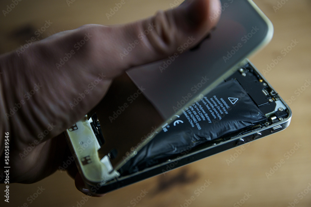 Iphone with exploded Lithiumion battery. Liion swollen battery Stock