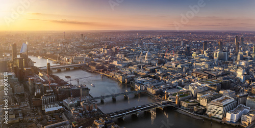 Panoramic view over the skyline of London city with Thames River, St. Pauls Cathedral, Blackfriars and Southwark during a golden sunset, England photo