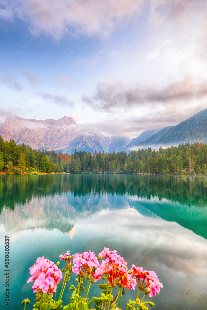 Incredible view of sunset over Fusine lake with Mangart peak on background.