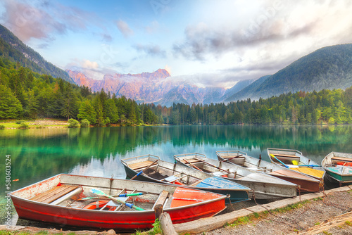 Incredible view of sunset over Fusine lake with Mangart peak on background.