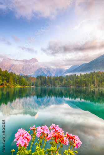 Obraz na płótnie Incredible view of sunset over Fusine lake with Mangart peak on background. w salonie