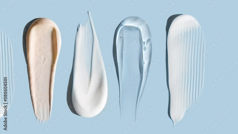 cosmetic smears cream texture on pastel blue background