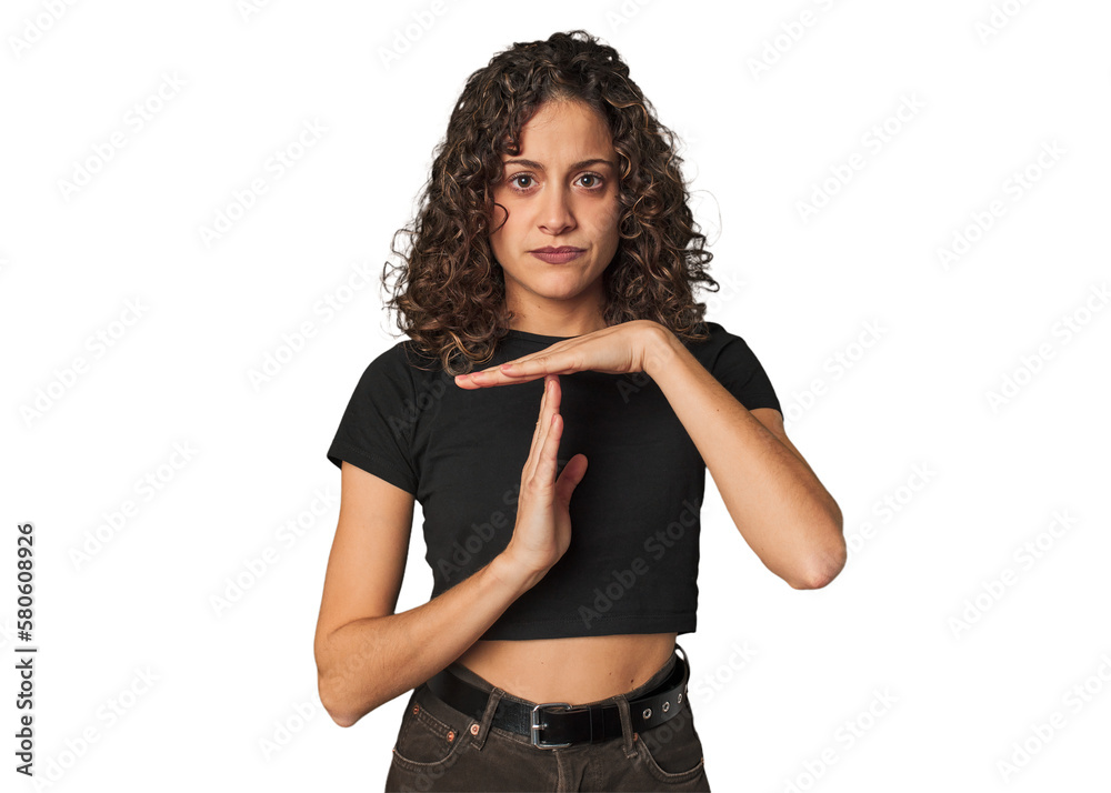 Radiant young woman with stunning curls showing a timeout gesture. Radiant young woman with stunning curls showing a timeout gesture.
