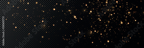 Golden sequins glow with many lights. Glittering dust. Luxurious background of golden particles.