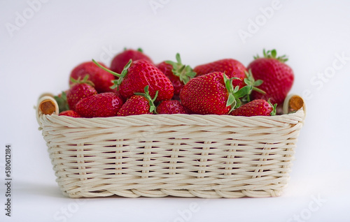 strawberries in a basket on a white background. Selective focus