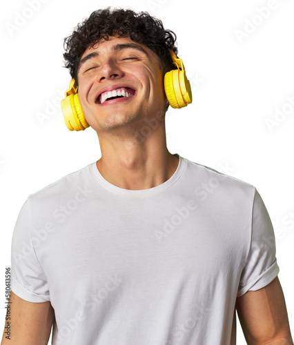 Фотография A young man enjoys his favorite tunes in high-quality sound, using wireless headphones for a relaxing and entertaining audio experience