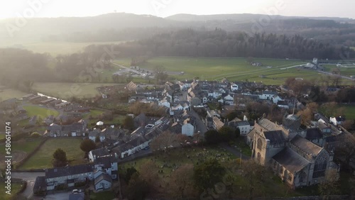 Cinematic aerial drone footage of Cartmel Village and Cartmel Priory. Shot at sunset. Cumbria UK. photo