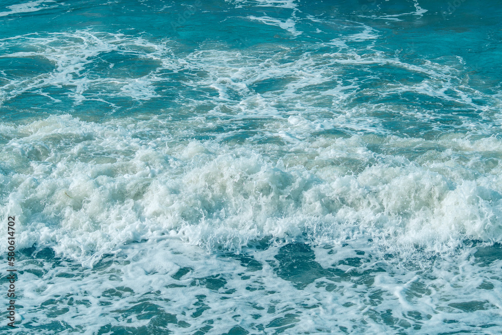 Background with sea waves. White foam on the surface of the water.