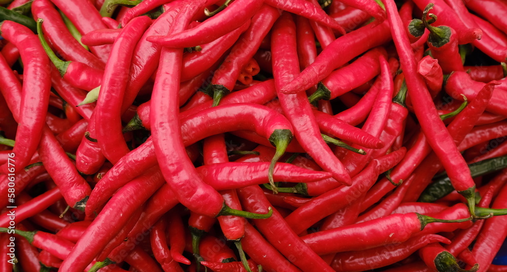 Close up fresh hot red chilli peppers from organic market