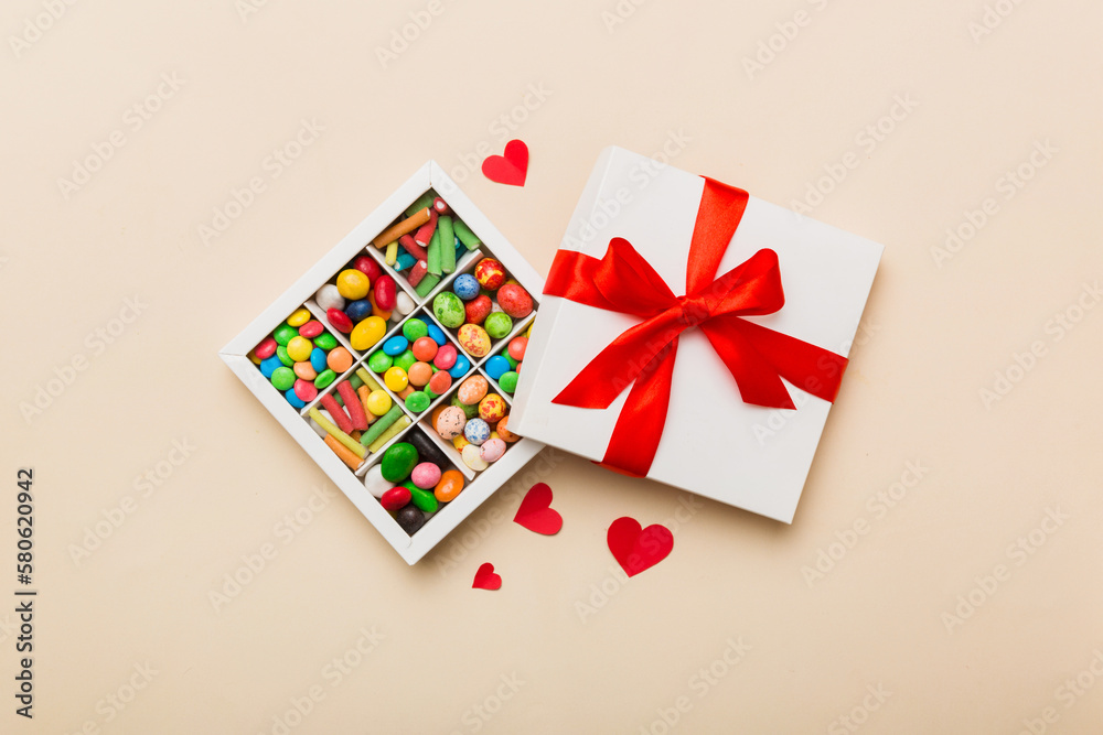 Valentine day composition: sweet candy, with gift boxes with bow and red felt hearts, photo template, background. Top View with copy space Valentine day composition: sweet candy, with gift boxes with bow and red felt hearts, photo template, background. Top View with copy space