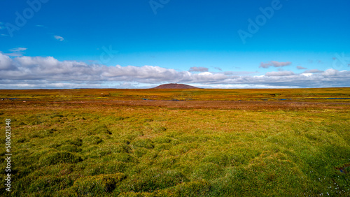 Panoramic view over a highland ex glacial land and surreal volcanic mossed landscape in Iceland, summer, with blue sky