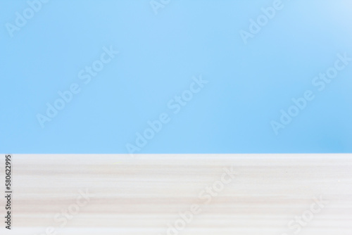 blur image of wood table with blue background