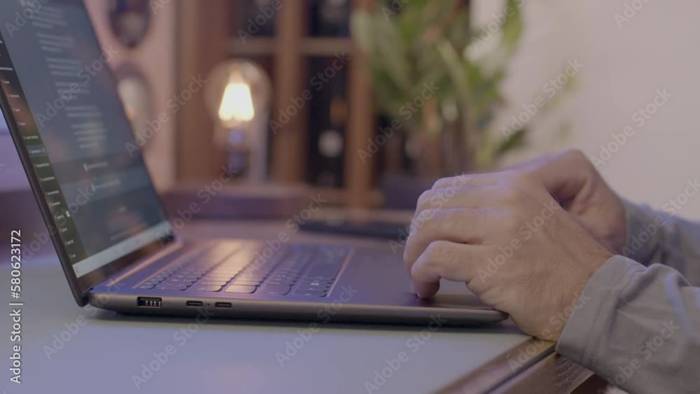 Elderly man using chatGPT to generate text on a notebook in living room