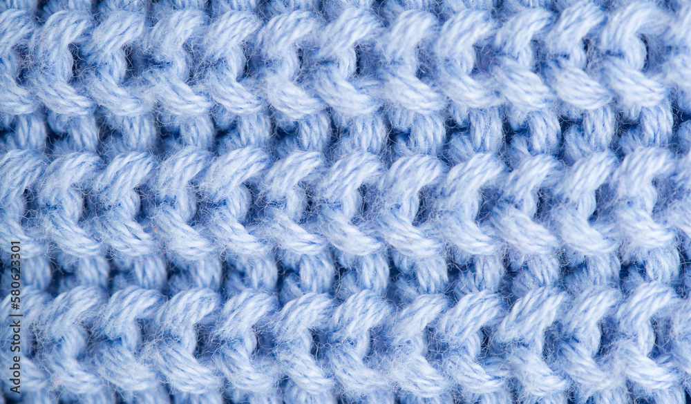 Background of knitted fabric with a pattern. Weaving winter clothes close-up. Background of knitted fabric with a pattern. Weaving winter clothes close-up.