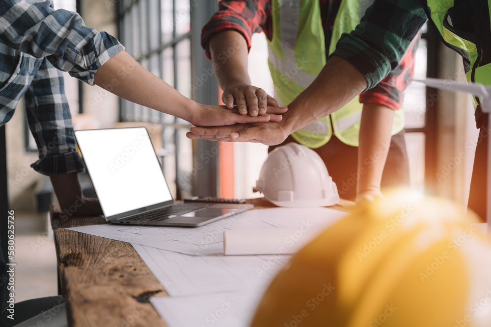 Obraz premium Team architects workers join hands to join forces to join forces to work for the industry for success. Teamwork and professional colleagues : Workers' hands, teamwork concept.