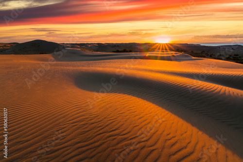 Picturesque desert landscape with a golden sunset over the dunes