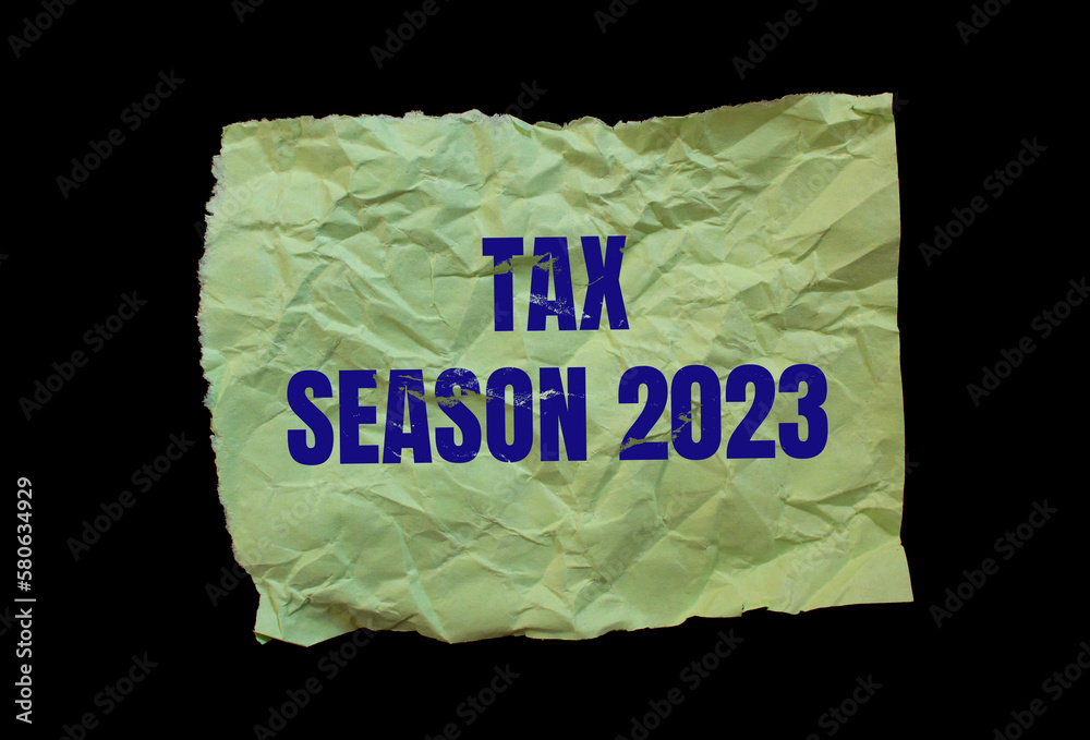 Tax Season 2023 words written on paper. Isolated on a black background. Business concept photo. Tax Season 2023 words written on paper. Isolated on a black background. Business concept photo.