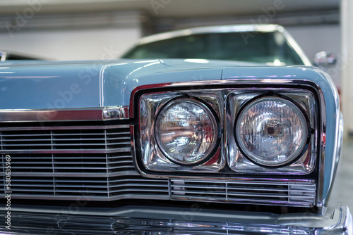 A close up look at a classic car. Retro automobile exterior scene. Front detail view of old vehicle.