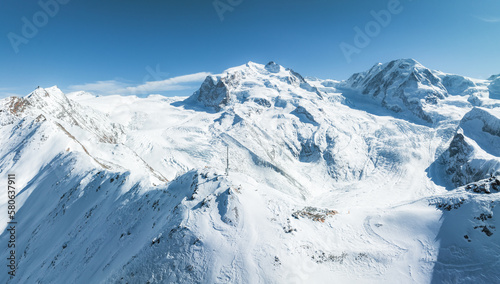 Beautiful Zermatt ski resort with view of the Matterhorn peak on the horizon. Beautiful Swiss Alps. © Aerial Film Studio
