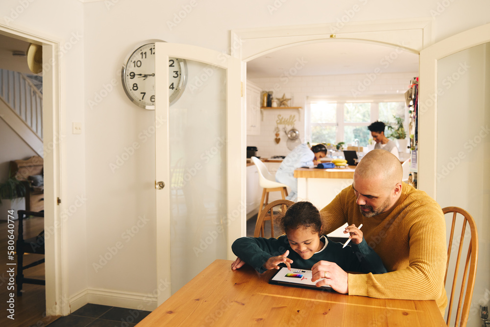 Multiracial father and son with Down syndrome using digital tablet Multiracial father and son with Down syndrome using digital tablet