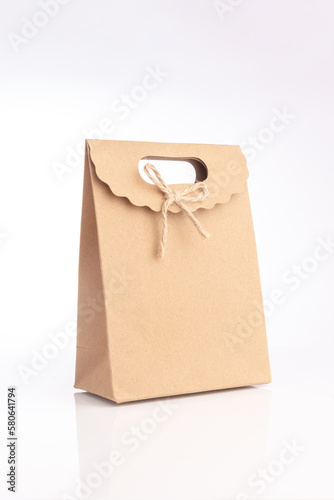 Small size light present brown cardboard bag with rope loop mockup on white background