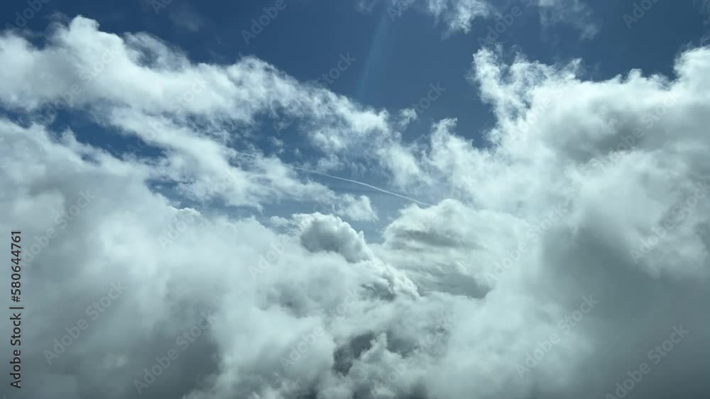 An unique pilot’s perspective: flying trough the clouds in a splendid sunny day. Pilot point of view.