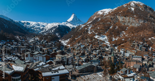 Aerial view on Zermatt Valley town and Matterhorn Peak in the background in the morning in Switzerland. Magical Swiss town with no cars and electric trains going up the mountains.