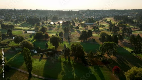 Wide aerial view of a well maintained golf course at sunrise in Oak Harbor, Washington. photo